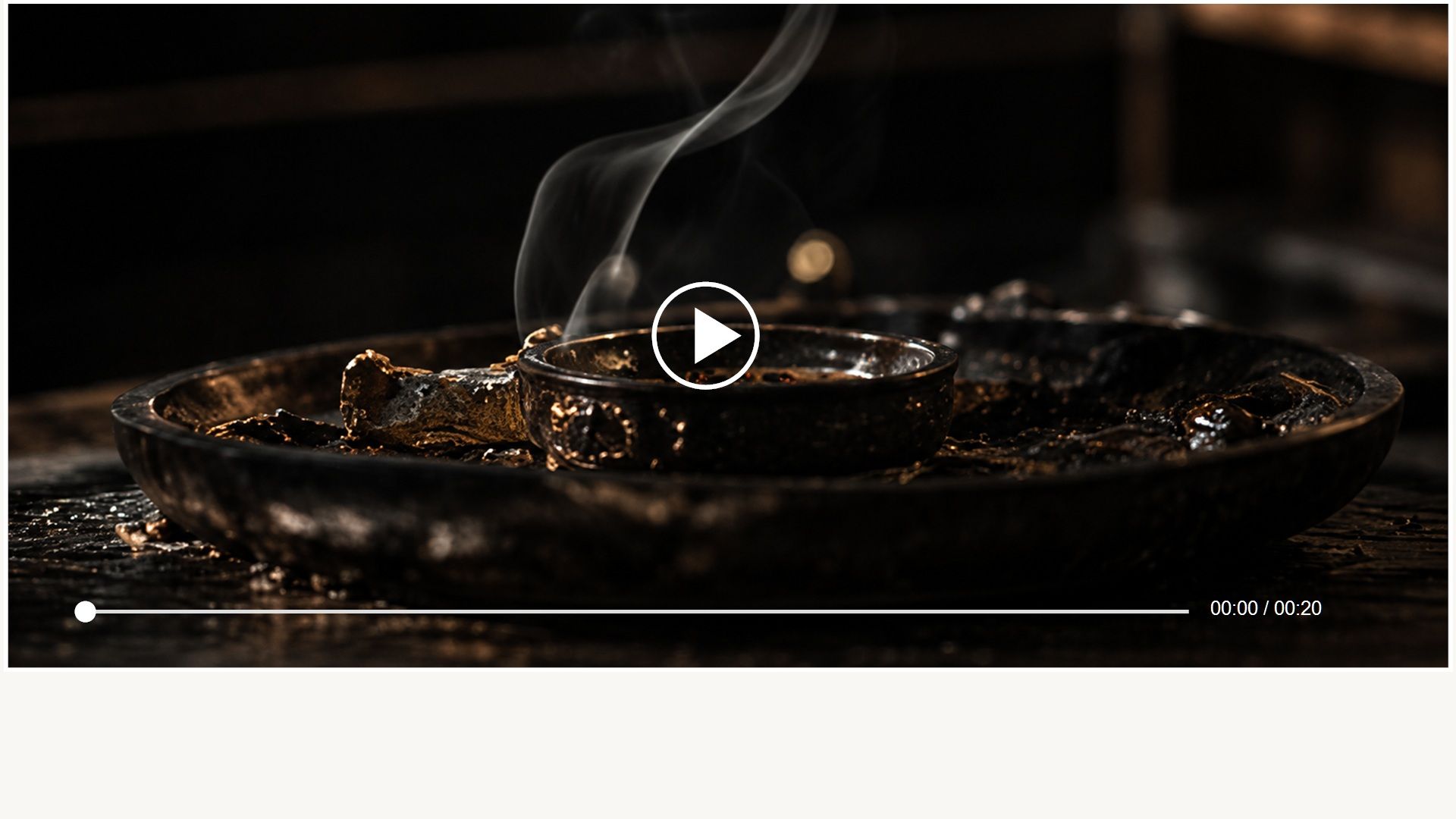Incense smoke drifting above a dark table setting
